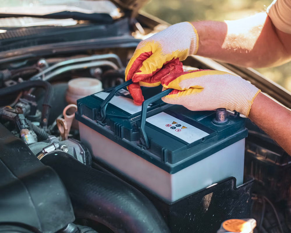 Mechanic replacing car battery